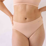 Woman wearing the SIx Ada seamless ribbed underwear set of Bralette and high rise knicker. Suitable to wear throughout pregnancy, maternity and for breastfeeding as a nursing bra and post C section knicker.