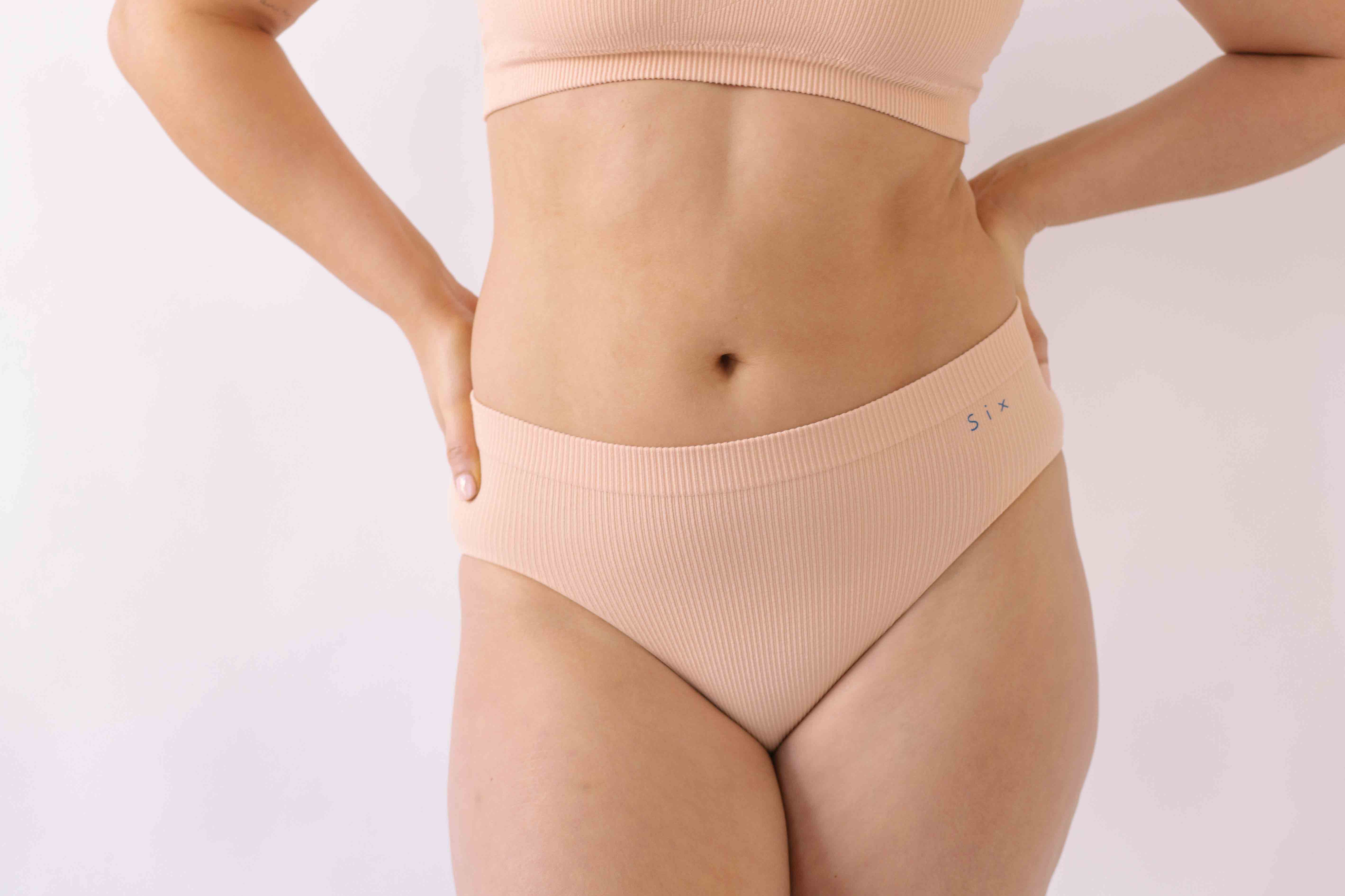 Woman wearing the SIx Ada seamless ribbed underwear set of Bralette and high rise knicker. Suitable to wear throughout pregnancy, maternity and for breastfeeding as a nursing bra and post C section knicker.