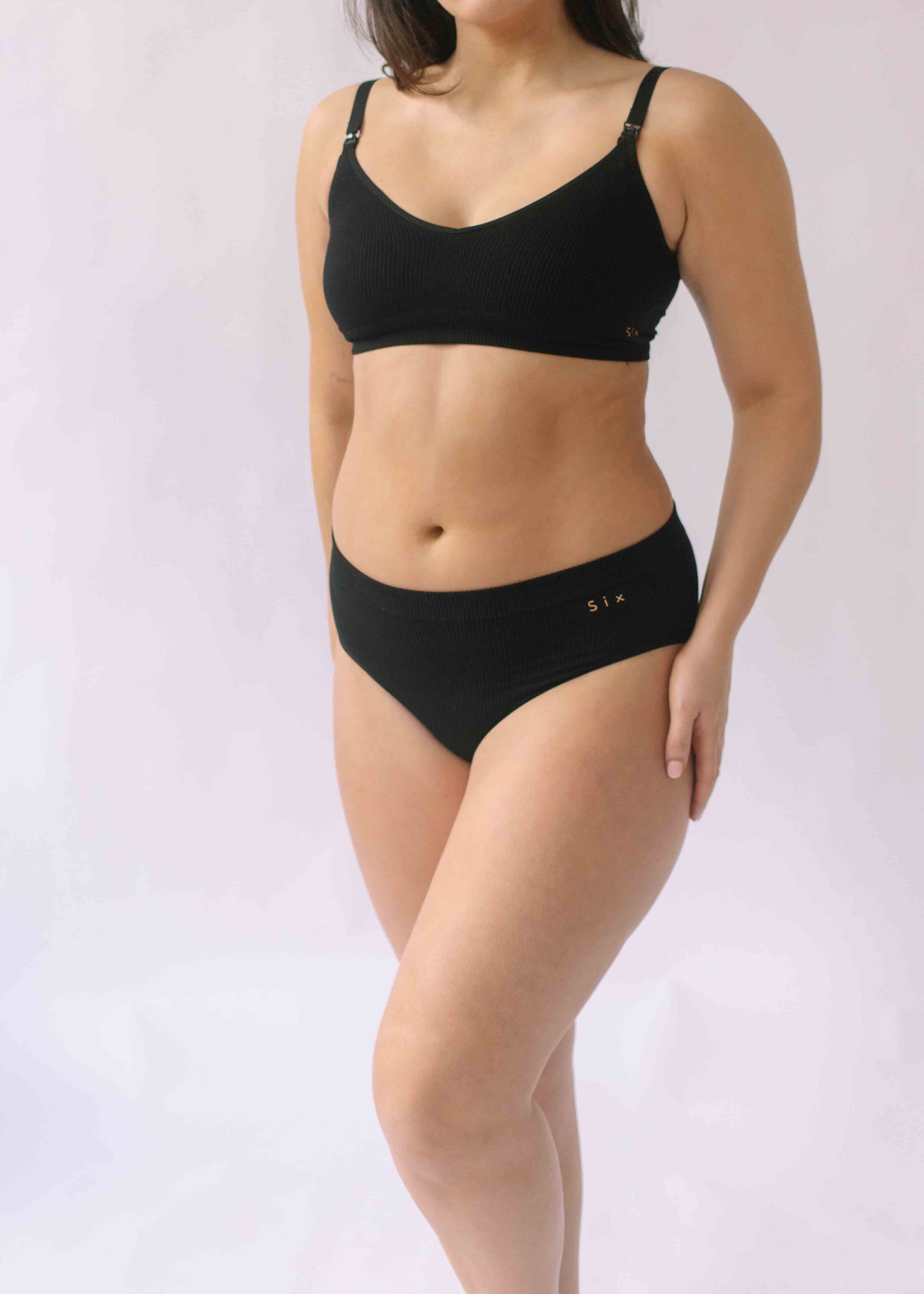 A woman wearing the Six Ada seamless underwear set in Black. Supportive and comfortable Bralette and high rise knicker style, suitable to wear for Maternity, breasfeeding, nursing bra, pregnancy and yoga.