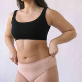 Woman wearing the SIx Ada seamless ribbed underwear set of Bralette and high rise knicker. Suitable to wear throughout pregnancy, maternity and for breastfeeding as a nursing bra and post C section knicker.