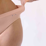 Woman wearing the Ada ribbed seamless high waisted knicker from Six. Suitable to wear throughout pregnancy, maternity and as a supportive post C section knicker.