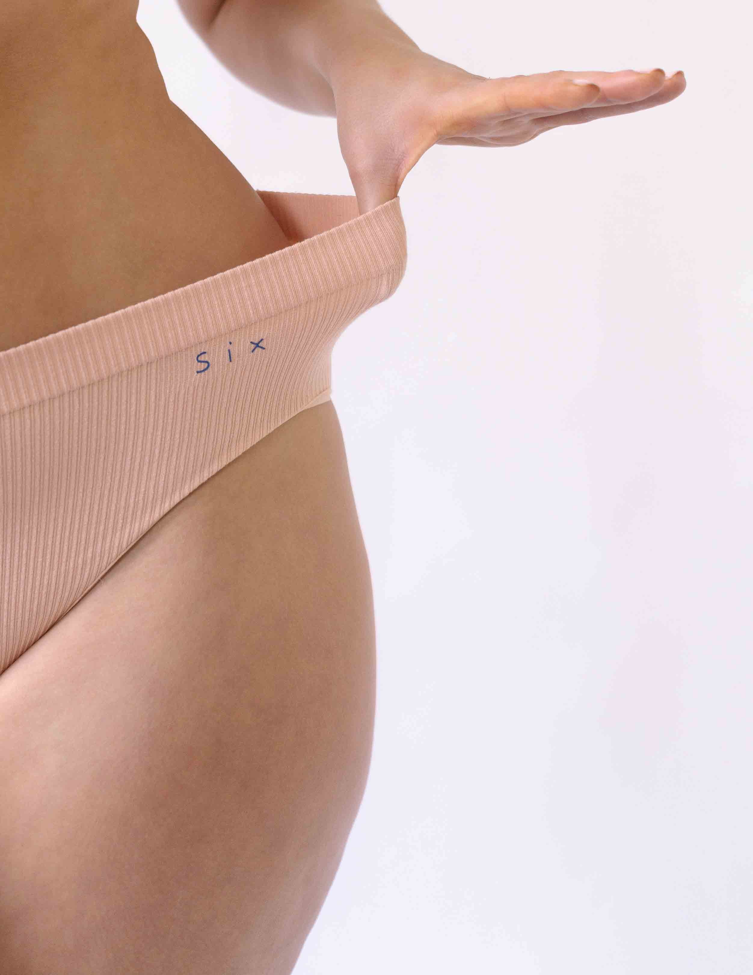 Woman wearing the Ada ribbed seamless high waisted knicker from Six. Suitable to wear throughout pregnancy, maternity and as a supportive post C section knicker.