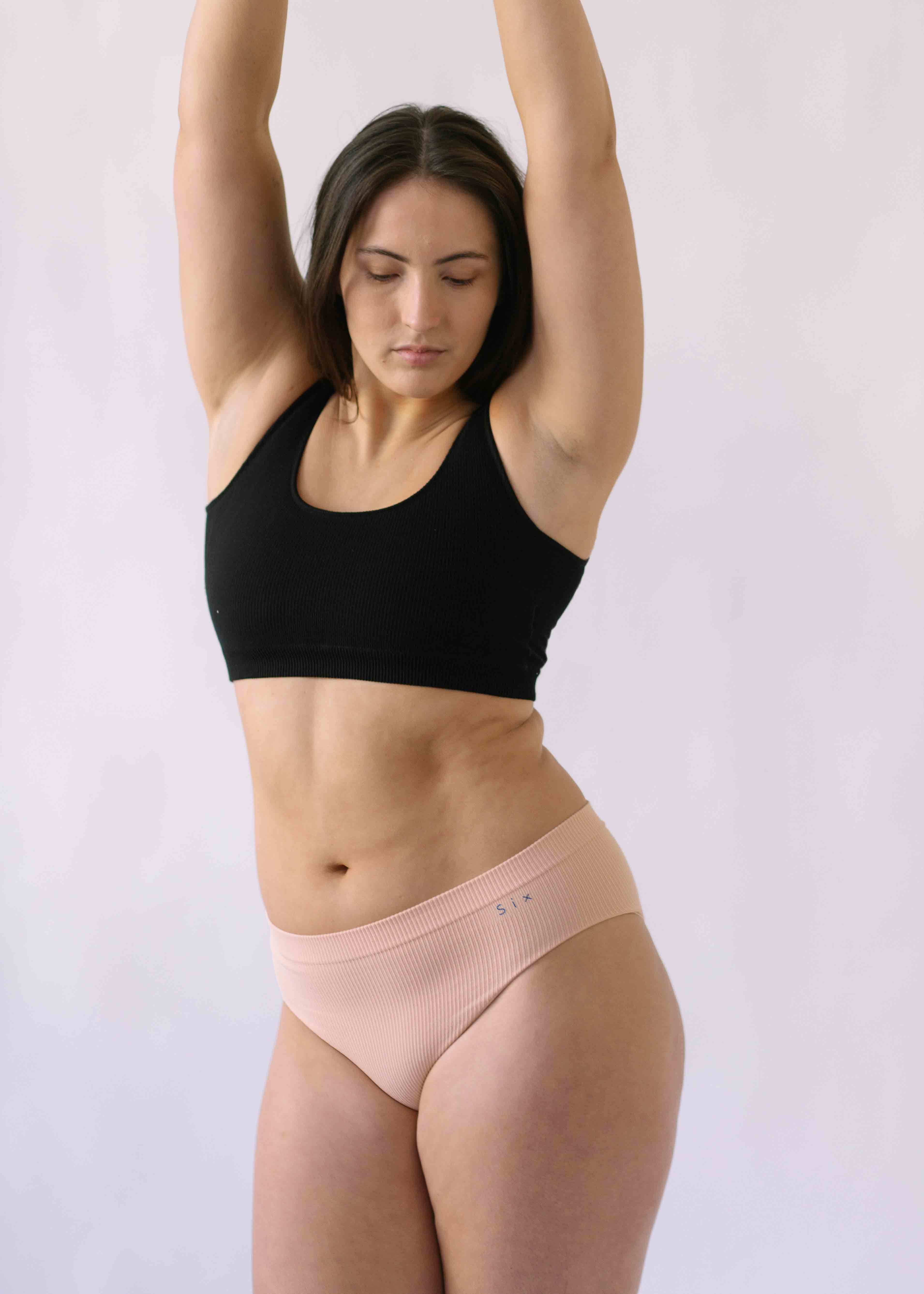 Woman wearing Black Six Ada seamless Bralette and deep knickers, Supportive and comfortable underwear for pregnancy, maternity, breastfeeding and yoga