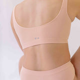 Woman wearing the SIx Ada seamless ribbed underwear set of Bralette and high rise knicker. Suitable to wear throughout pregnancy, maternity and for breastfeeding as a nursing bra and post C section knicker.