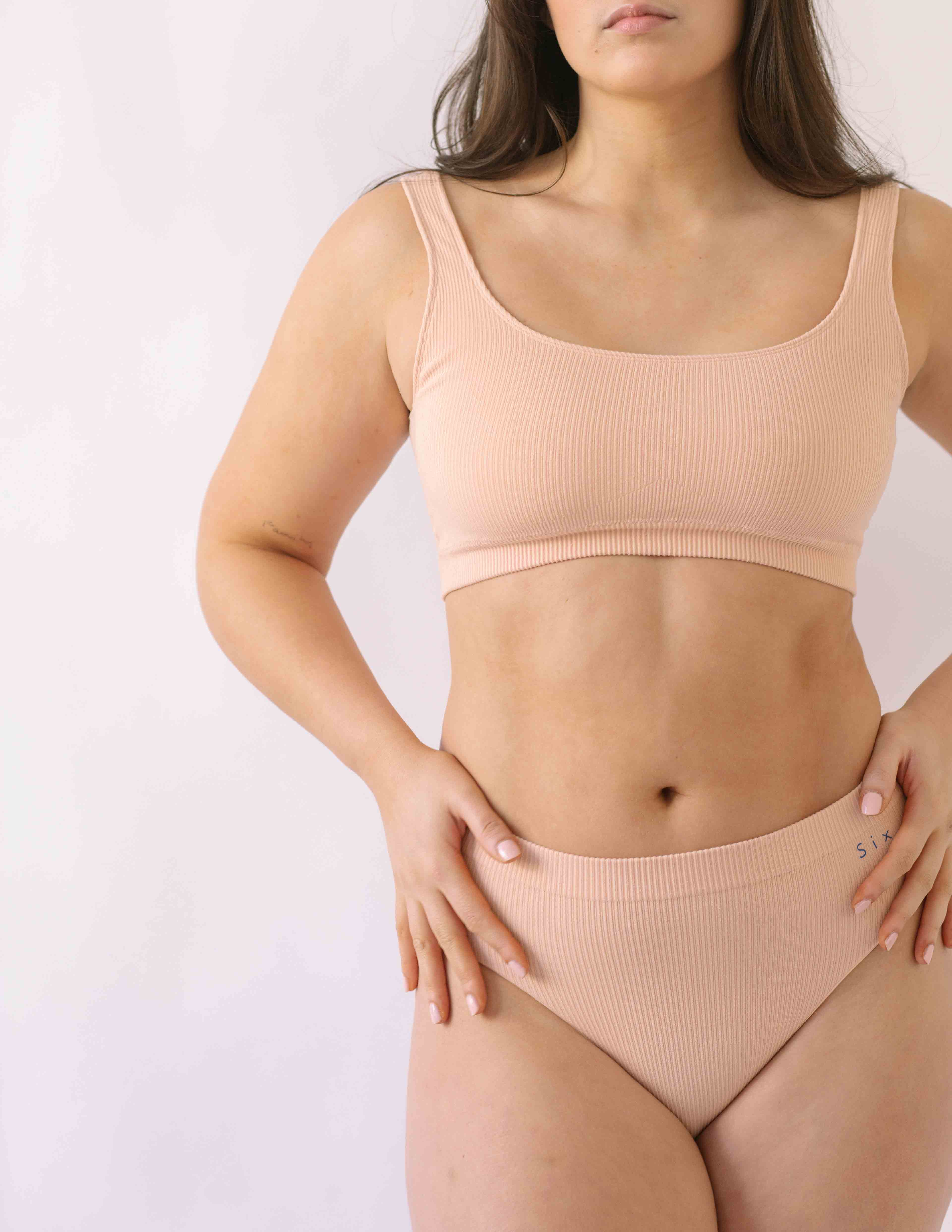 Woman wearing the SIx Ada seamless ribbed underwear set of Bralette and high rise knicker. Suitable to wear throughout pregnancy, maternity and for breastfeeding as a nursing bra and post C section knicker.