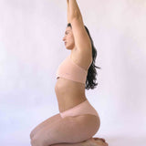 Woman wearing the nude blush coloured Six Ada seamless ribbed nursing bra and high waisted knicker. Comfortable and supportive and suitable for pregnancy and breastfeeding.