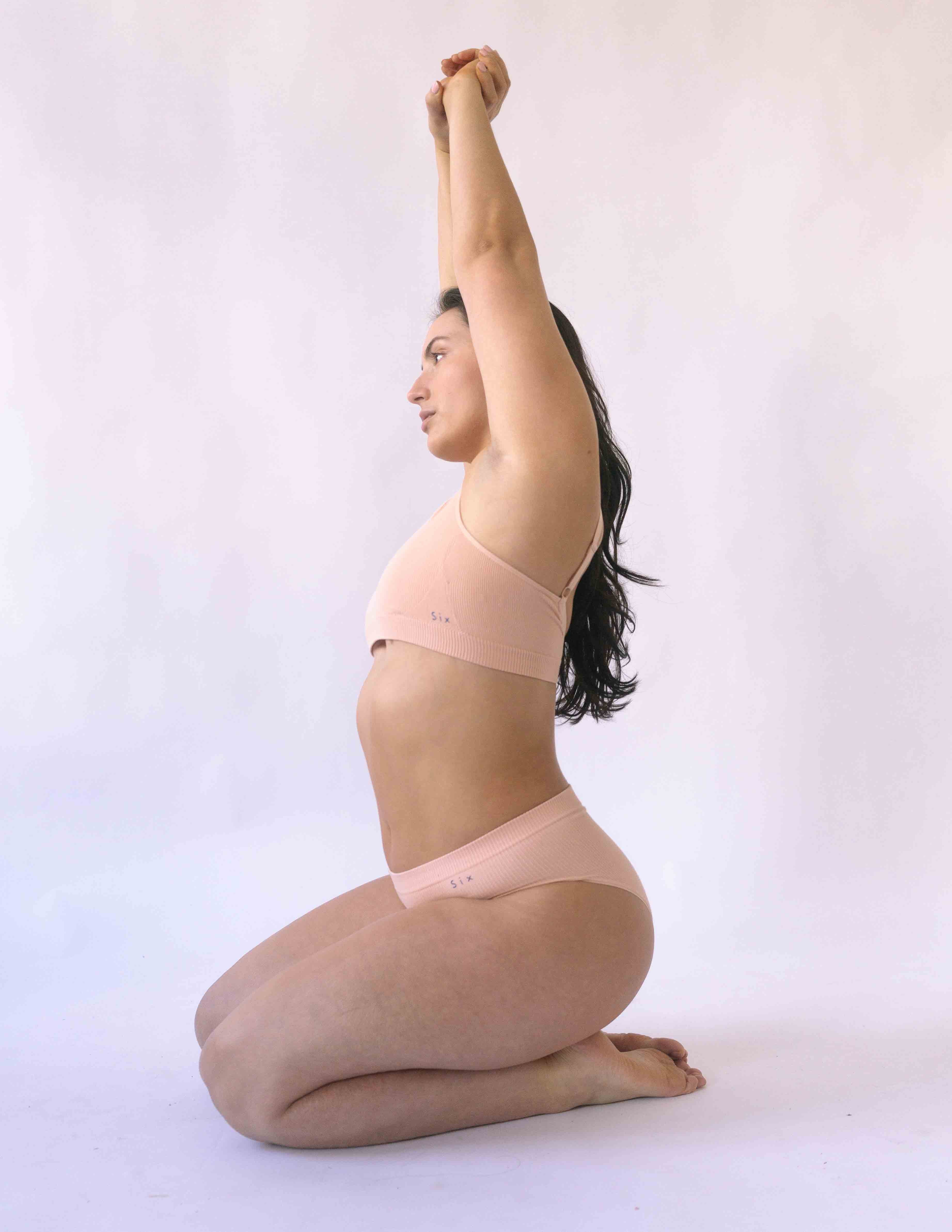 Woman wearing the nude blush coloured Six Ada seamless ribbed nursing bra and high waisted knicker. Comfortable and supportive and suitable for pregnancy and breastfeeding.
