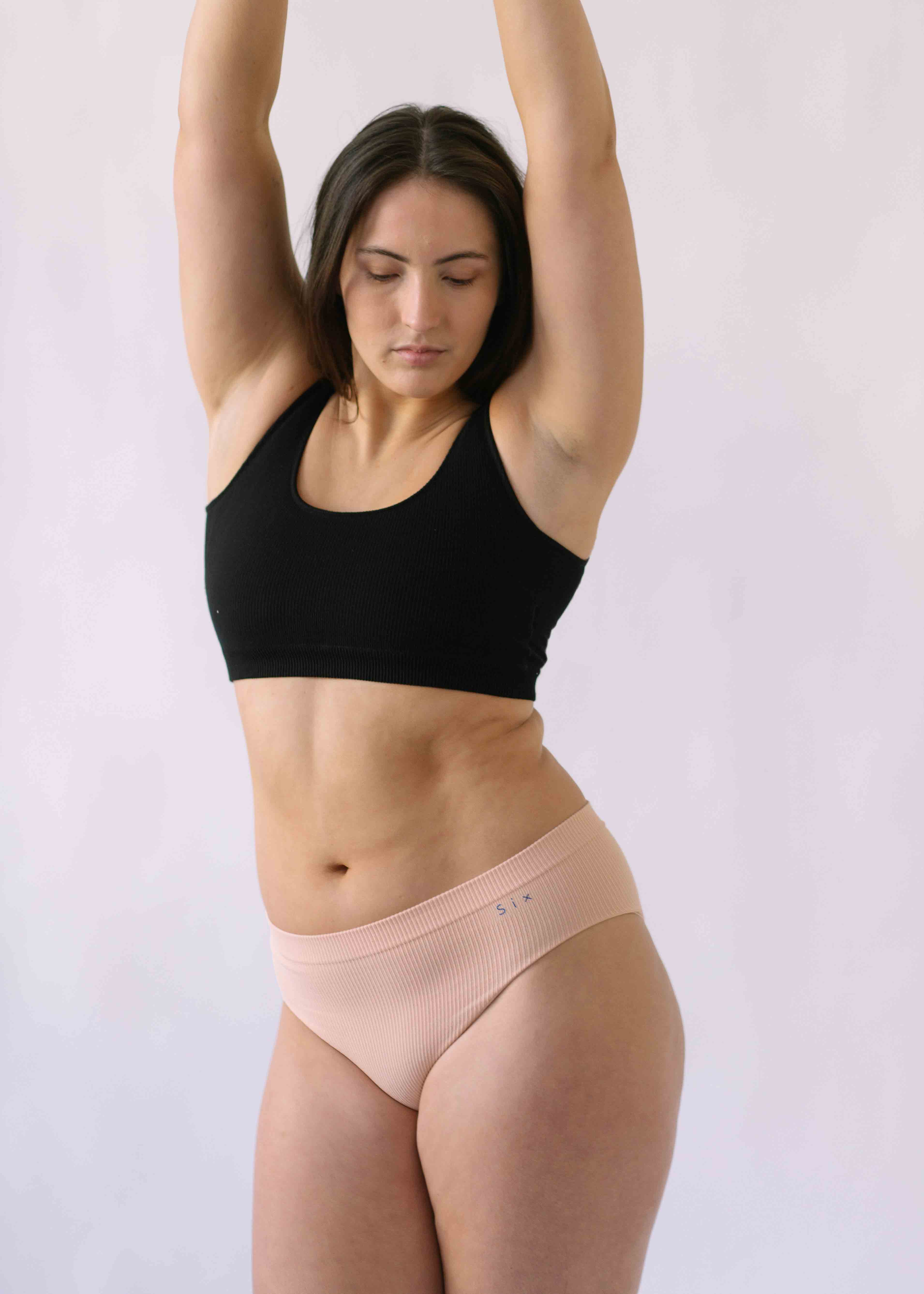 Woman wearing Black Six Ada seamless Bralette and deep knickers, Supportive and comfortable underwear for pregnancy, maternity, breastfeeding and  yoga