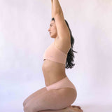 Woman wearing the nude blush coloured  Six Ada seamless ribbed nursing bra and high waisted knicker. Comfortable and supportive and suitable for pregnancy and breastfeeding.