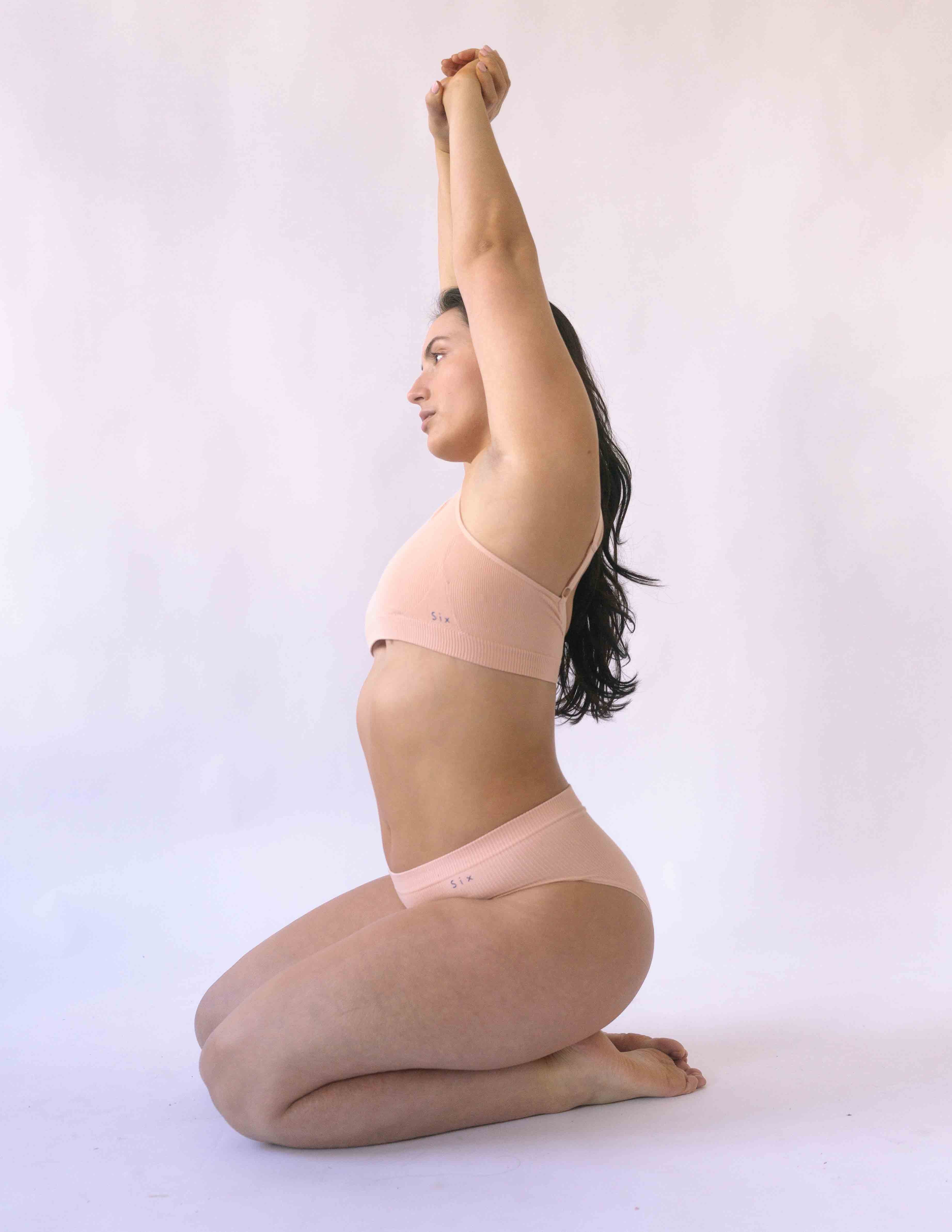 Woman wearing the nude blush coloured  Six Ada seamless ribbed nursing bra and high waisted knicker. Comfortable and supportive and suitable for pregnancy and breastfeeding.